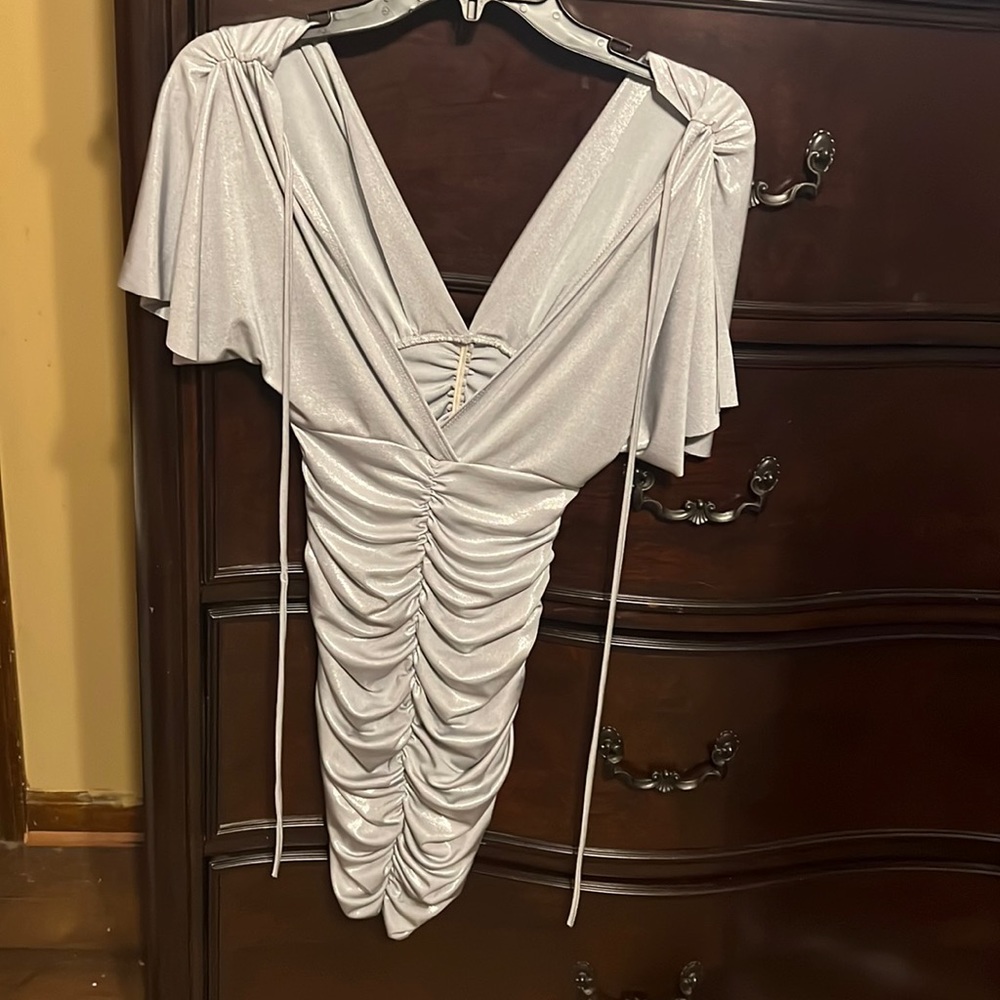 A silver dress in a size small....that is brand new and never worn